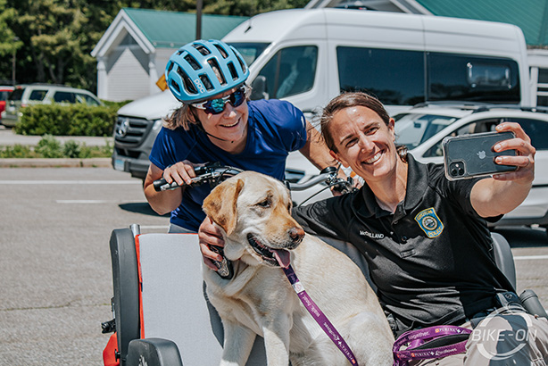 Two women and a yellow lab ride and snap a selfie on a Van Raam Chat