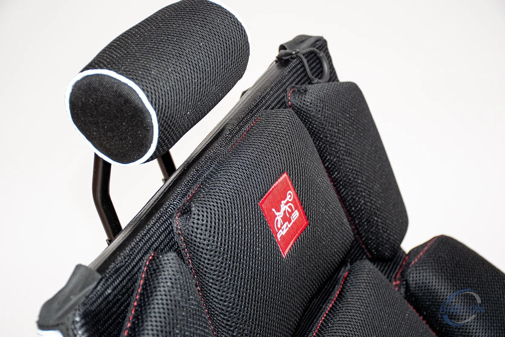 AZUB Ti-FLY 20 Black seat with red and white logo embroidered below the head rest
